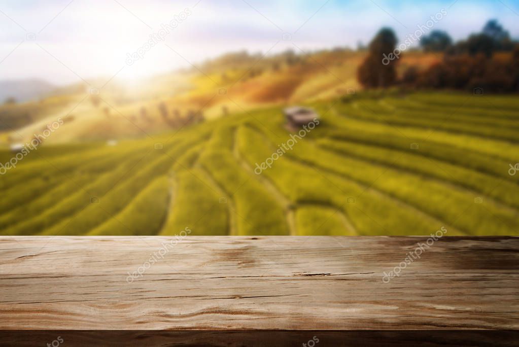 Wood table in autumn landscape with empty space.