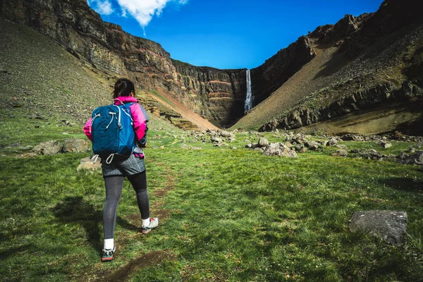 Caminhadas de viajantes em Hengifoss Waterfall, Islândia . — Fotografia de Stock