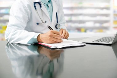 Pharmacist writes on documents at pharmacy. clipart