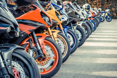 Motorcycles group parking on city street in summer clipart