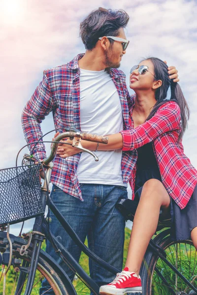 Happy young couple ride bicycle on the hills.