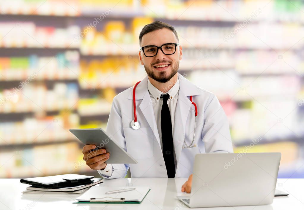 Pharmacist using tablet computer at pharmacy.