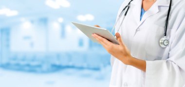 Hastanede tablet bilgisayar kullanan bir doktor..