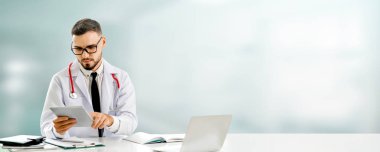 Hastanede tablet bilgisayar kullanan bir doktor..