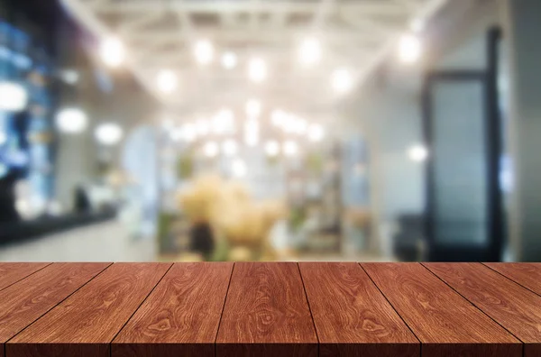 Wood table in blur background of modern restaurant