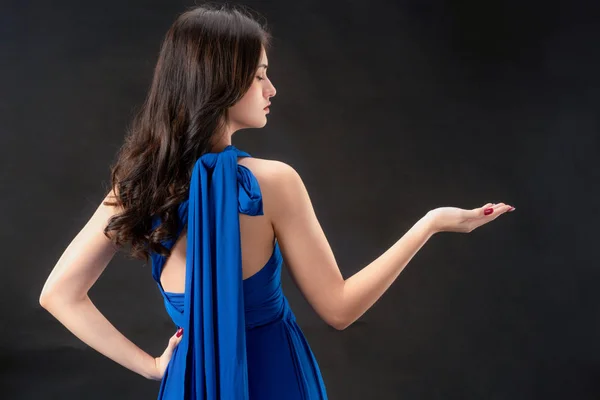 Beautiful woman fashion model in blue dress.