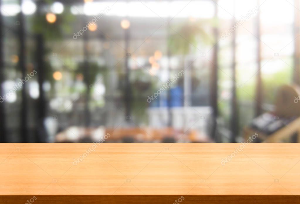 Wood table in blur background of modern restaurant