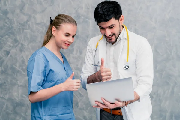 Médico y enfermera trabajando con computadora portátil . — Foto de Stock