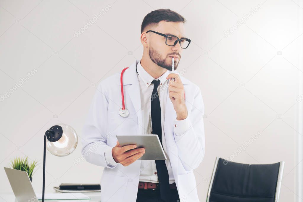 Doctor working on tablet computer in the hospital.