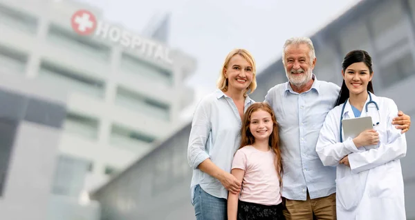 Doctor with happy family at hospital.