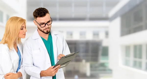 Doctors working with colleague in the hospital. — Stock Photo, Image