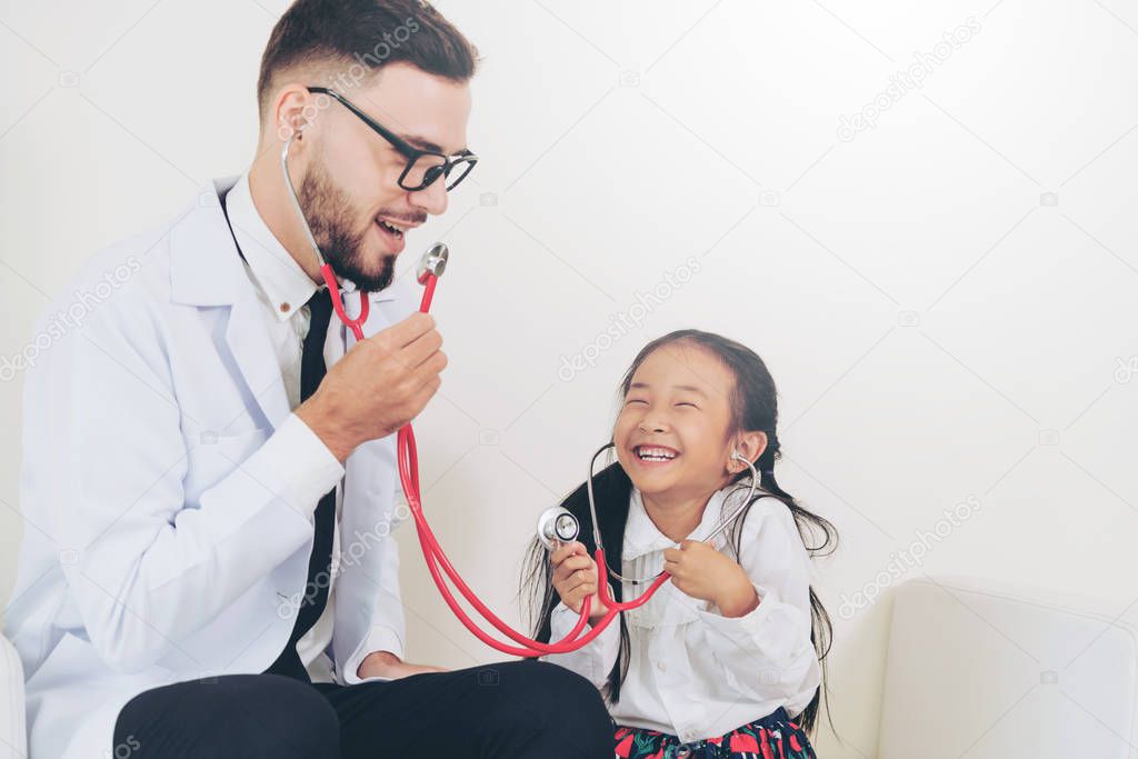 Happy little kid visit doctor in hospital office.