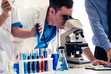 Kimya laboratuvarında çalışan bir grup bilim adamı.