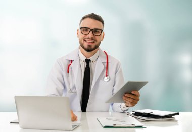 Hastanede tablet bilgisayar kullanan bir doktor..