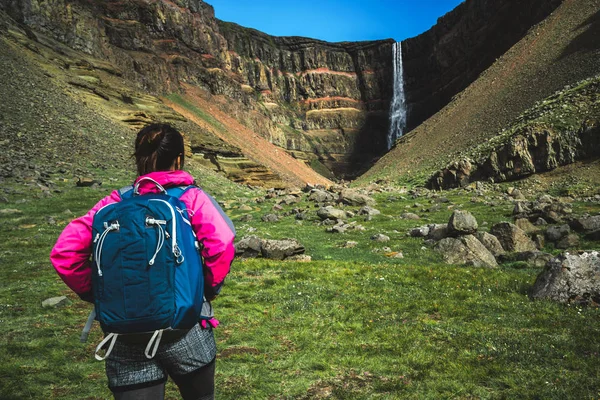 Caminhadas de viajantes em Hengifoss Waterfall, Islândia . — Fotografia de Stock