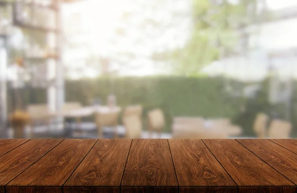 Wood table in blur background of modern restaurant — Stock Photo, Image