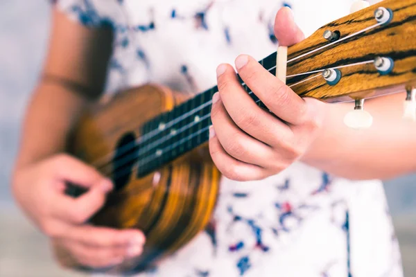 Happy woman musician playing ukulele in studio. — Stock Photo, Image