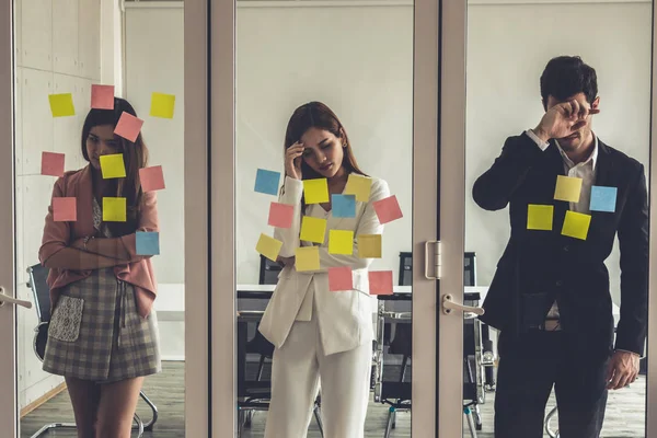 Unhappy business people standing in office.