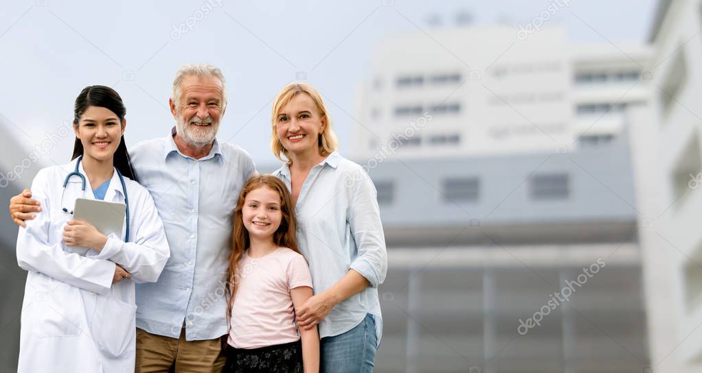 Doctor with happy family at hospital.
