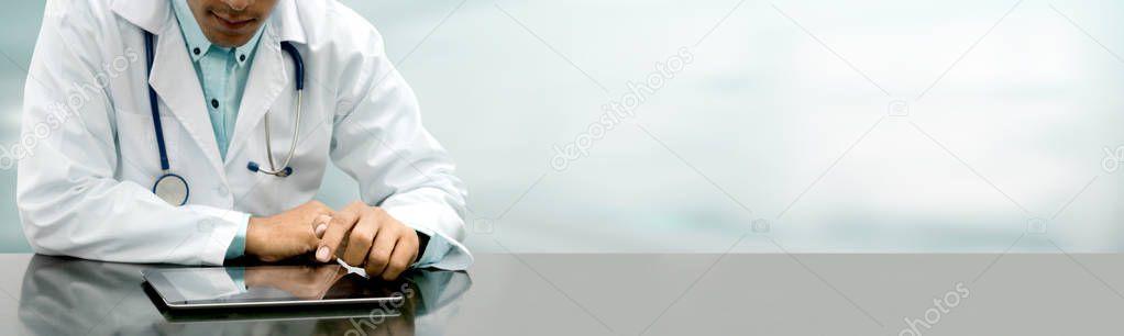 Doctor with tablet computer at hospital office.