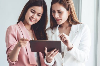 Ofiste tablet bilgisayar kullanan iş kadınları.