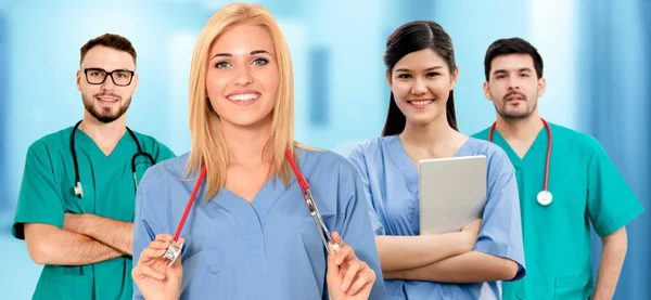 Doctor working in hospital with other doctors. — Stock Photo, Image