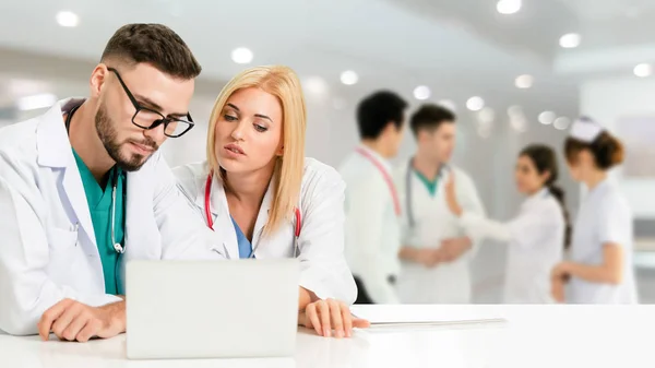 Médico que trabalha no hospital com outros médicos . — Fotografia de Stock