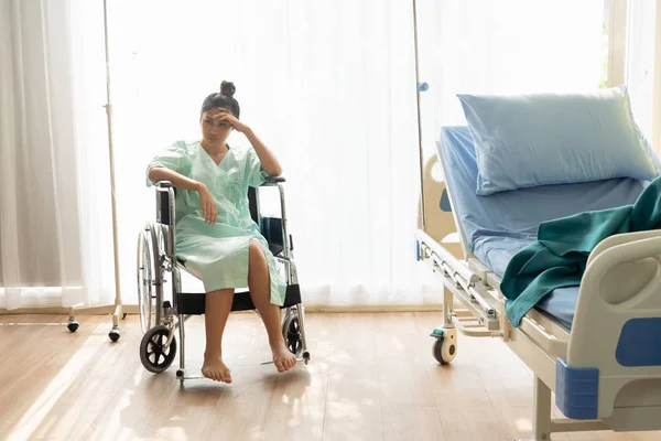 Paciente serio sentado en silla de ruedas en el hospital . — Foto de Stock