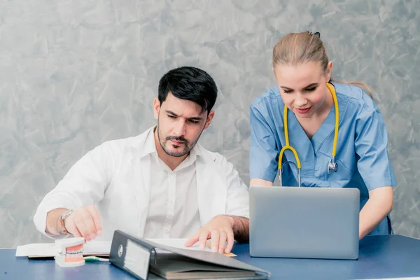 Médico e enfermeiro trabalhando com computador portátil . — Fotografia de Stock