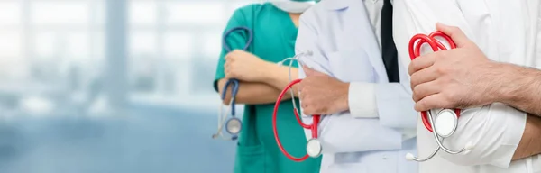 Doctor working in hospital with other doctors. — Stock Photo, Image