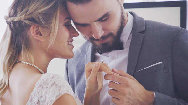 Bride and groom in wedding dress prepare ceremony.