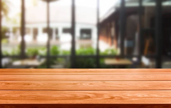 Wood table in blur background of modern restaurant — Stock Photo, Image