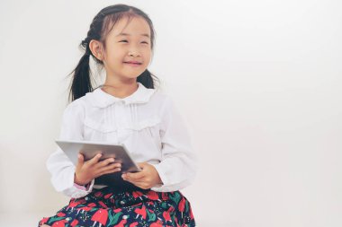 Tablet ile beyaz arka plan üzerinde küçük çocuk.