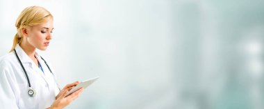 Hastanede tablet bilgisayar kullanan bir doktor..