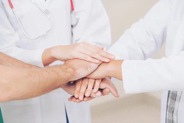 Médico, cirujano y enfermera unen sus manos . — Foto de Stock