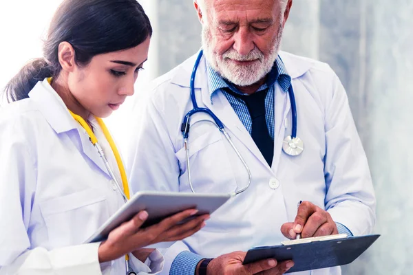 Doctors working with tablet computer at hospital. — Stock Photo, Image