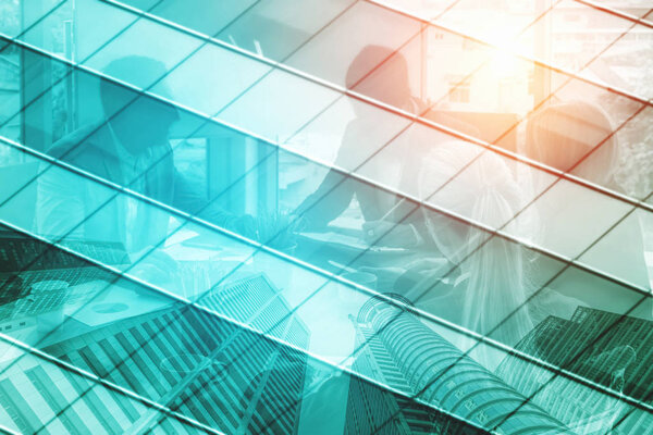 Double exposure image of faded business abstract background with office building and people conference group meeting showing partnership success of business deal.