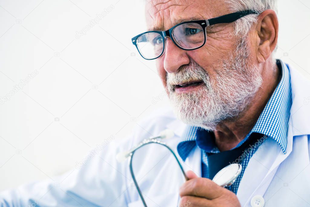 Senior male doctor working in hospital.