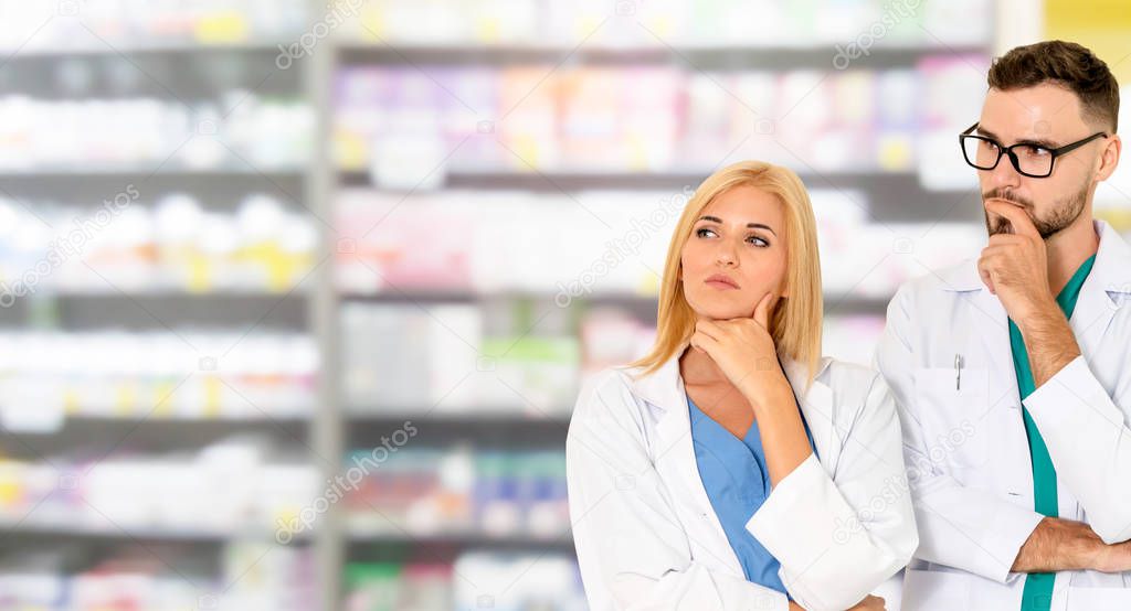 Pharmacist working with colleague in pharmacy.