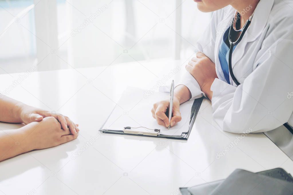 Woman Doctor and Female Patient in Hospital Office