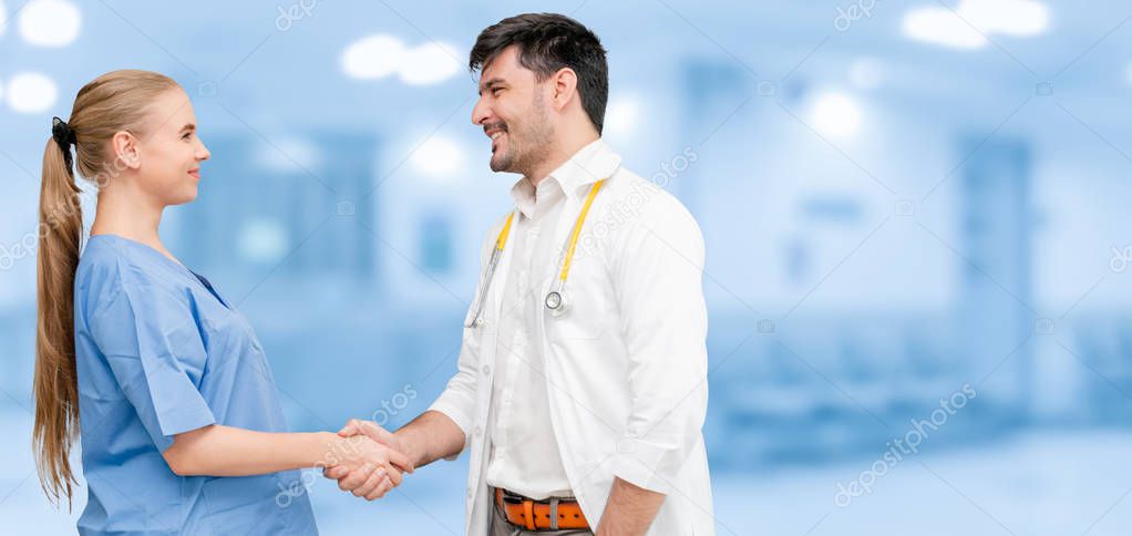 Doctor in hospital handshake with another doctor.