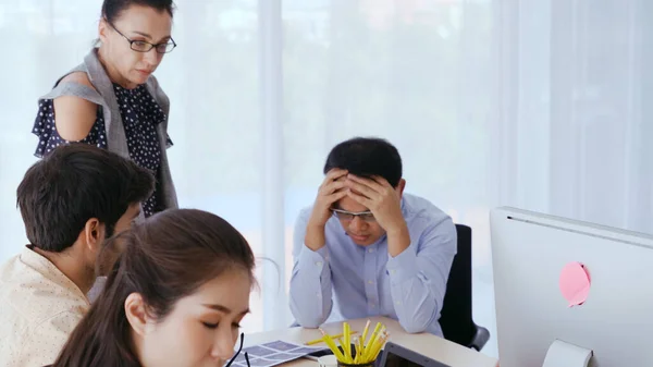 Unhappy business people in group meeting in office. The team is frustrated because of project failure. Business problem and crisis concept.