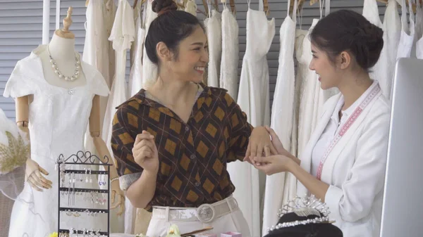 Future bride customer talking with wedding store shopkeeper