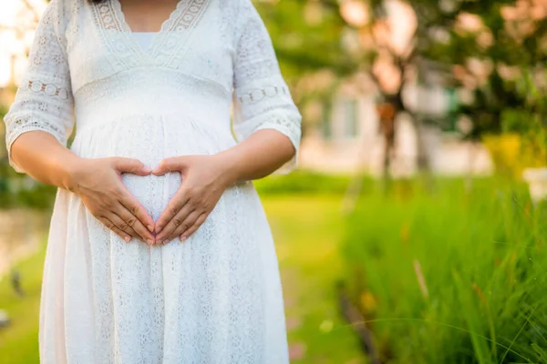 Mujer embarazada sintiéndose feliz en casa jardín. — Foto de Stock