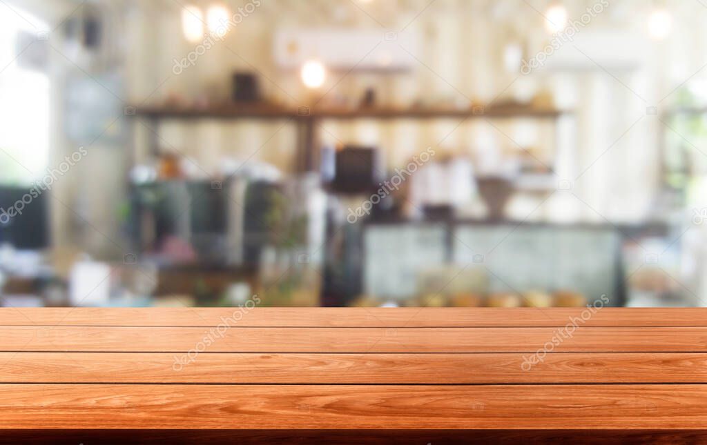 Wood table in blur background of modern restaurant