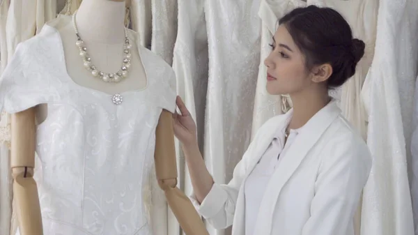 Future bride choosing wedding dress for her upcoming wedding cer