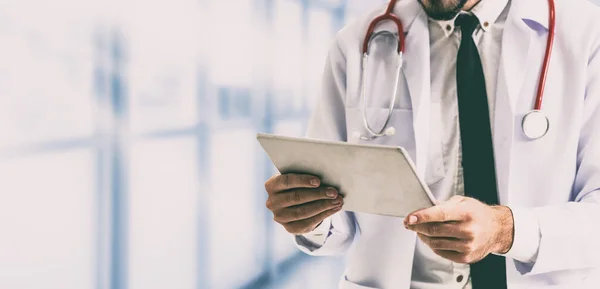 Doctor using tablet computer at the hospital. Medical healthcare and doctor staff service.