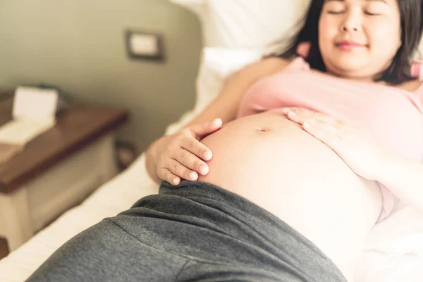 Pregnant woman feeling happy at home