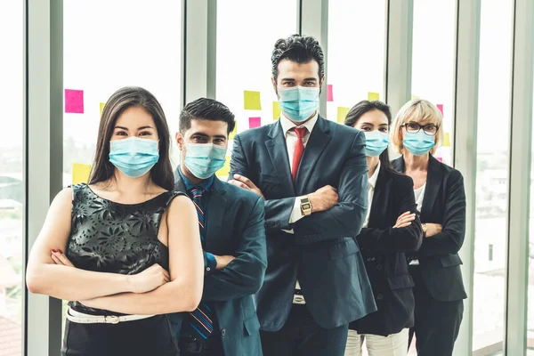 Confident business people with face mask protect from Coronavirus or COVID-19. Concept of help, support and collaboration together to overcome epidemic of Coronavirus or COVID-19 to reopen business.