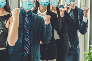 Confident business people with face mask protect from Coronavirus or COVID-19. Concept of help, support and collaboration together to overcome epidemic of Coronavirus or COVID-19 to reopen business. clipart